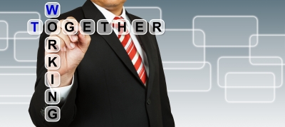 Businessman With Wording Working Together- image courtesy of PinkBlue at freedigitalphotos.net.jpg